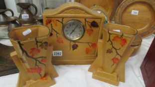 A 1930's ceramic three piece clock set.