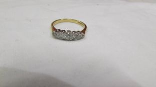 An 18ct yellow gold five stone diamond ring, size O.