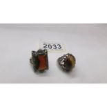 A silver ring set Tiger's eye and another silver ring set amber coloured stone.