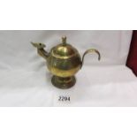 A vintage brass whale oil lamp in the for of a kettle/aladdin lamp.