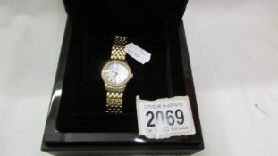 A boxed gold plated Christopher Ward Swiss made women's wrist watch with diamonds.