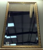 A gilt framed bevel edged mirror.