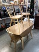 An Ercol drop leaf dining table and 4 chairs