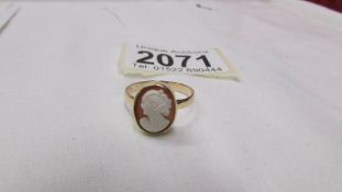An early 20th century gold cameo ring with profile of a young lady, size O.