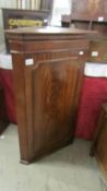 A Victorian mahogany corner cupboard having shaped shelves with brass galleries. (Collect only).