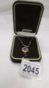 A 9ct gold pendant set purple stones.