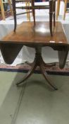 A mahogany drop side table on brass lion paw feet. (Collect only).