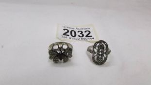 A silver marcasite butterfly ring and another silver marcasite ring.