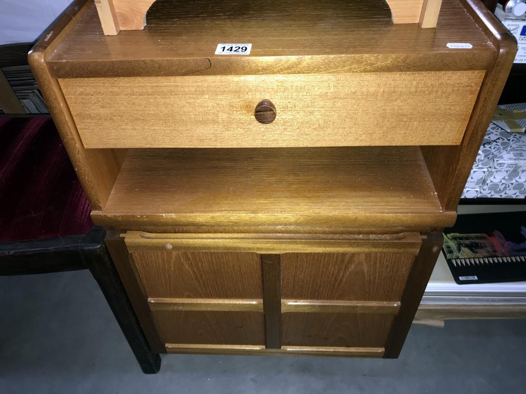 A 1970's teak bedside unit with cupboard & drawer