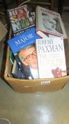 A box of assorted politics related books.