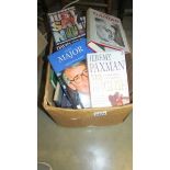 A box of assorted politics related books.