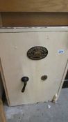 A heavy Griffith's & Sons, Wolverhampton safe with key. (Collect only).