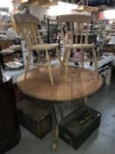 A round solid pine dining table (top not fixed) and 2 chairs (table diameter 122 cm x 78 cm high)