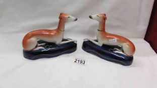 A pair of Staffordshire greyhound pen stands.