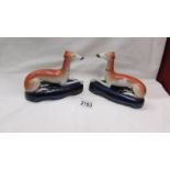 A pair of Staffordshire greyhound pen stands.