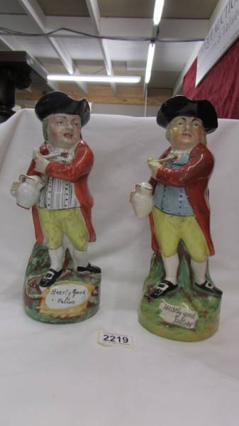 Two 19th century Staffordshire Toby jugs, "Hearty Good Fellow" with different colourways.