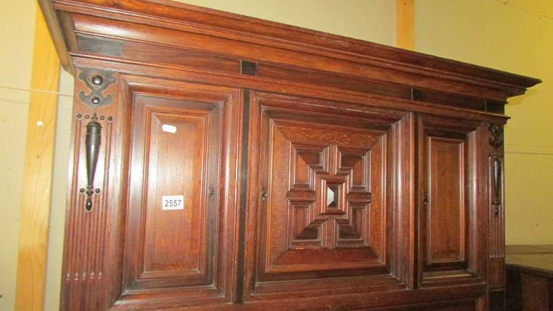 A Victorian dark oak cupboard with two drawers and two doors. (Collect only). - Image 2 of 3