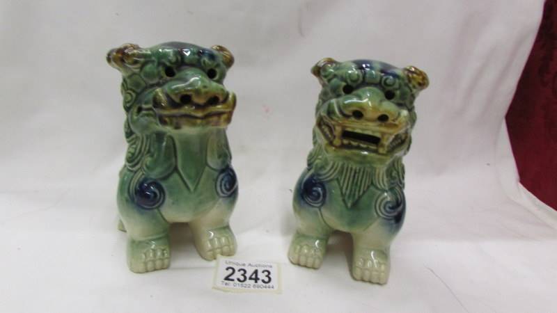 A pair of green pottery Dogs of Fo.