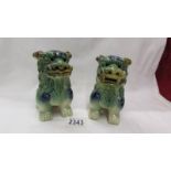 A pair of green pottery Dogs of Fo.