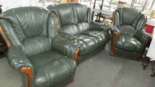 A good quality wood framed green leather three piece suite. (Collect only).