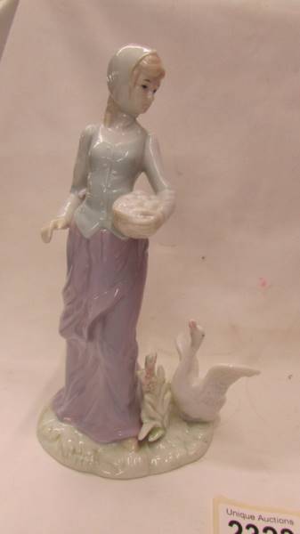 A boxed NAO by Lladro Flamenco dancer and another unboxed and unmarked figure of a lady with a duck. - Image 4 of 4