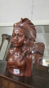 A carved hard wood female bust.