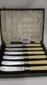 A cased set of six sterling silver fruit knives, Sheffield crown, sterling silver lion,