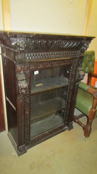 A carved oak pier cabinet, (needs some repair). (Collect only).
