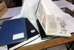 A part album of Israeli stamps and 2 books of world stamps plus an empty folder