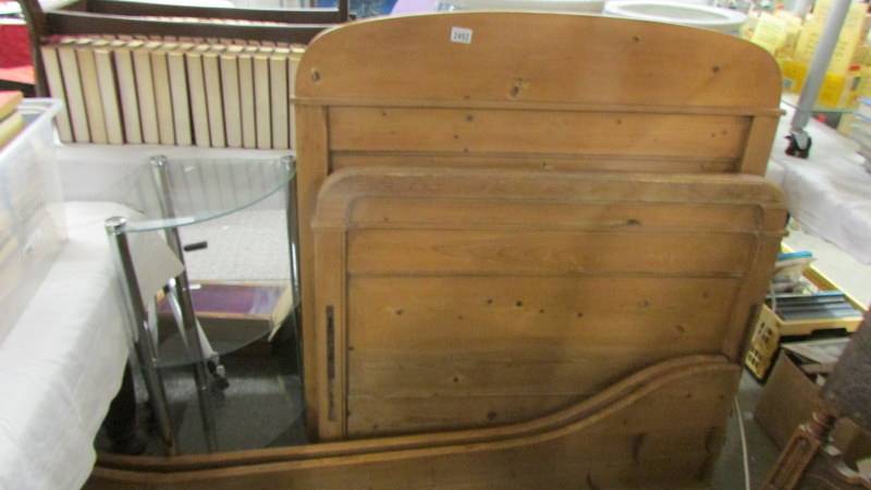 A pine sleigh bed complete with side rails. (Collect only).