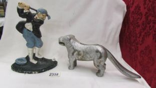 A cast metal dog nut cracker and a golf related door stop.