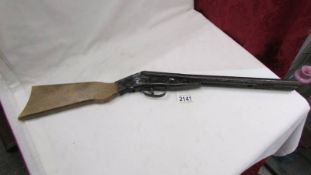 A vintage toy metal and wood cork gun.