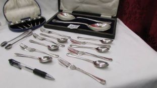 A cased set of six silver spoons, a cased pair of silver plate serving spoons,