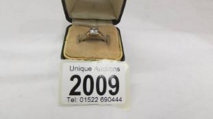 An 18ct white and yellow gold 90 pt square stone diamond ring. Size M half.