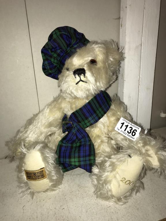 A Merrythought 2000 blond bear with growler tartan sash and hat