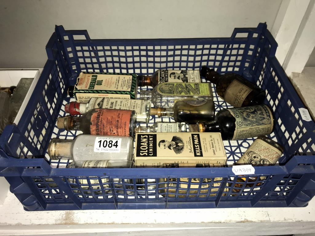 A quantity of vintage bottles with various advertising labels including Sloans liniment etc.