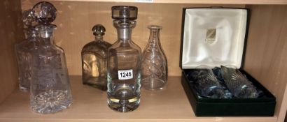 5 glass decanters, 1 engraved with golfer,