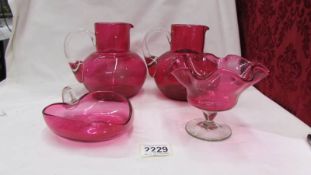 Two cranberry glass jugs and two cranberry glass dishes. (Collect only).