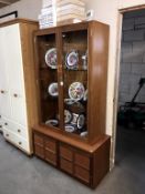 A teak veneered 2 door cupboard