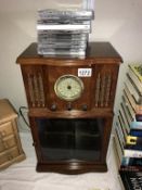 A Steepletone Glastonbury vintage radio style CD player with a quantity of CD's