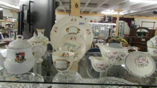 A Canada/USA commemorative trio, A Three piece Bristol Pottery tea set, 2 other teapots and a vase.
