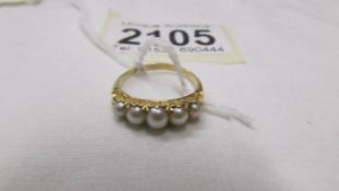 A yellow metal ring set five pearls, size M. (tests as 18ct gold).