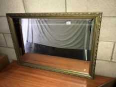 A large gilt framed bevel edge mirror