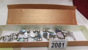 A silver gem set bracelet set with cultured pearl, abalone shell in heavy silver.