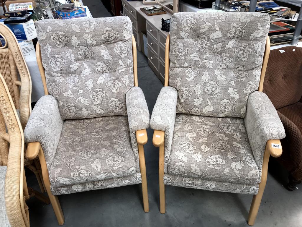 A pair of cream floral fabric covered Parker Knoll style armchairs