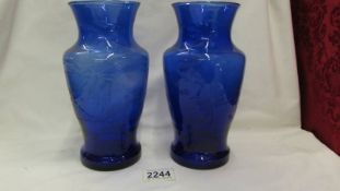 Two blue cut glass vases.