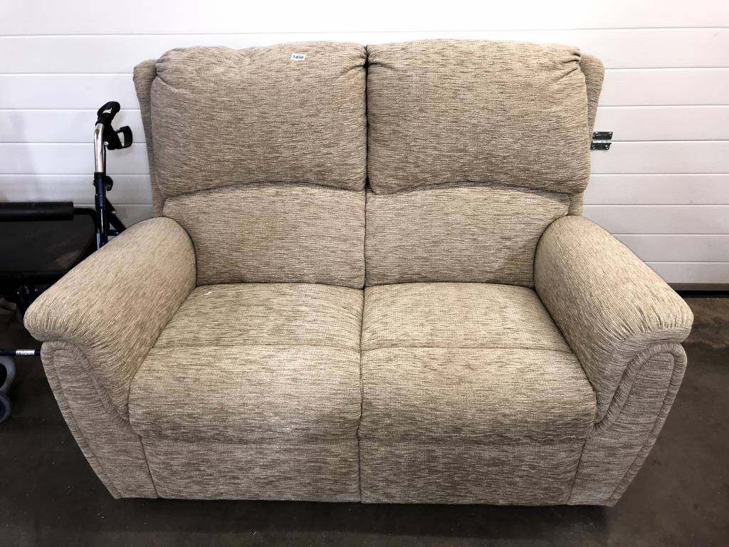 A cream fabric 2 seater sofa