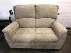 A cream fabric 2 seater sofa