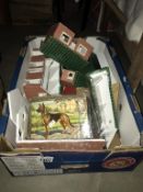 A large box of vintage toy farm building and accessories