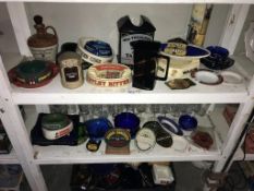 A quantity of breweriana on 3 shelves including ashtrays,